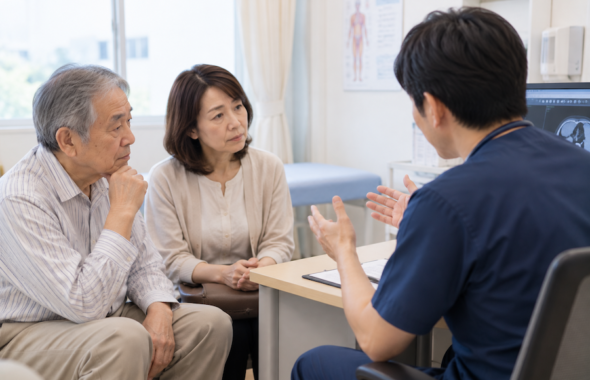 病院で医師の話を聞く患者さんとその家族